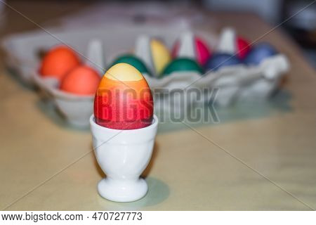 Colourful Self-dyed Easter Eggs In An Egg Cup And An Egg Carton, Germany