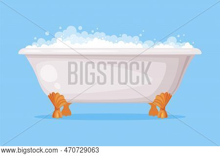 Cast Iron Bathtub On Claw Foot Pedestal Full Of Water With Soap Bubbles Foam Isolated On Blue Backgr