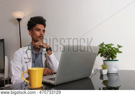 Brazilian Black Doctor Or Veterinarian Working At Home. Young Man Doing Home Office During The Day A