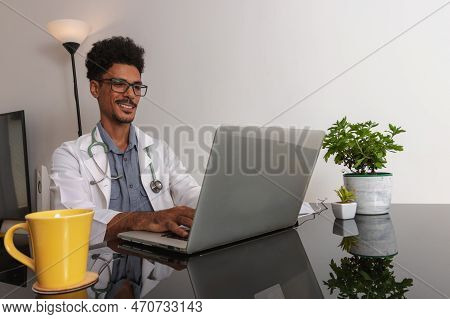 Brazilian Black Doctor Or Veterinarian Working At Home. Young Man Doing Home Office During The Day A