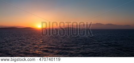 Rocky Island On Mediterranean Sea. Rinia Near Mikonos, Greece, Europe. Nature Background Panorama. S