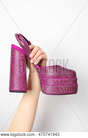 Woman Holding Fashionable Punk Square Toe Ankle Strap Pump On White Background, Closeup. Shiny Party