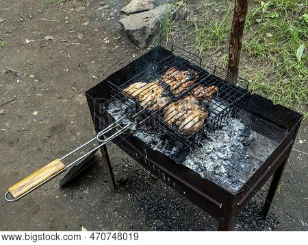 Meat Is Cooked On The Grill On The Grill In The Summer