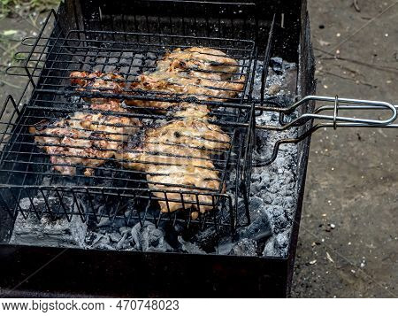 Meat Is Cooked On The Grill On The Grill In The Summer