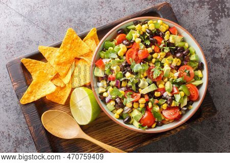 Homemade Cowboy Salad Or Texas Caviar Bean Dip Lime Dressing, Served With Tortilla Chips Closeup In 