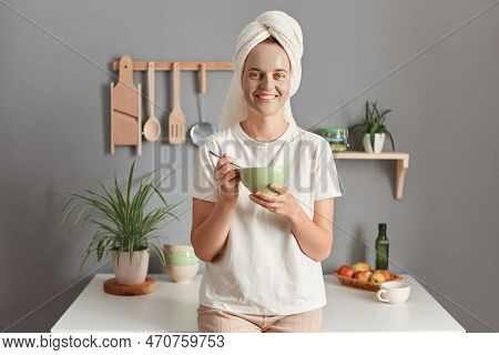 Portrait Of Smiling Young Adult Woman Wrapped White Towel And Dressed In T-shirt, Doing Cosmetology 