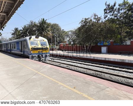 Closeup Of Beautiful Mandya Railway Station And Electric Train Moving On A Track.