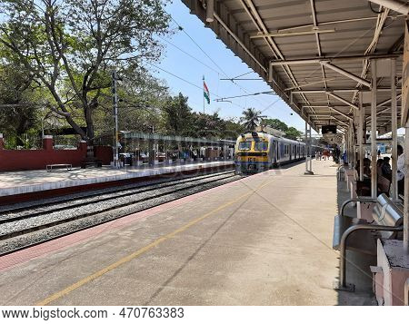 Closeup Of Beautiful Mandya Railway Station And Electric Train Moving On A Track.