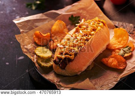 Chili Hot Dog With Onion And Mustard Served With Chips