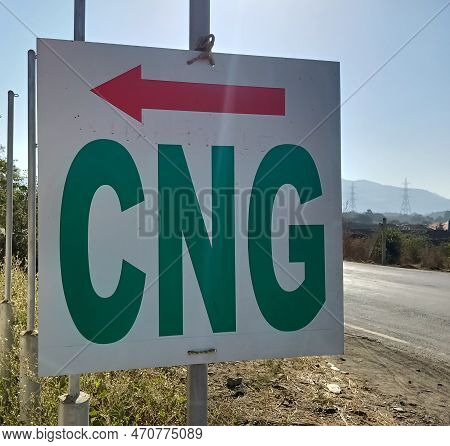 Cng Text Board With Direction Arrow On The Side Of The Road