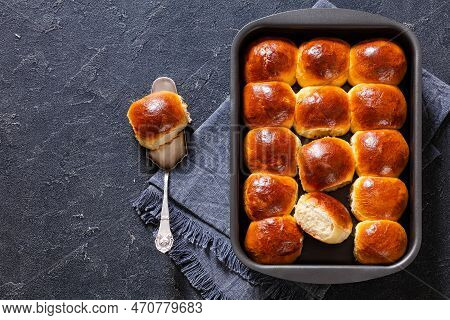 Hawaiian Sweet Rolls, Portuguese Sweet Bread, Soft And Stretchy Buns In Baking Dish On Concrete Tabl