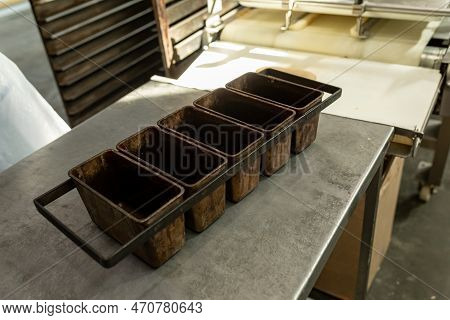 Empty Metal Molds For Baking Bread. Industrial Bakery Automated Line. Metal Containers For Baking Br