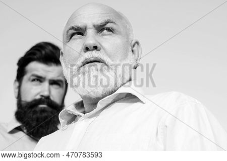 Two Different Generations Ages: Grandfather And Father Together. Grandfather With Son In Park. Grand