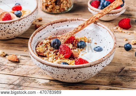 Healthy Brakfast With Yogurt And Baked Granola With Berries In Two Small Bowls, Granola Baked With N