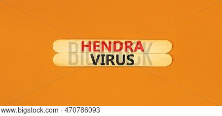 Hendra Virus Symbol. Concept Words Hendra Virus On Wooden Sticks. Beautiful Orange Table Orange Back
