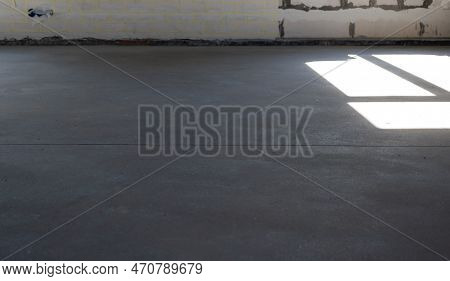 The Leveled Rough Floor In A House Under Construction With A Semi-dry Cement Screed Is A Smooth Surf