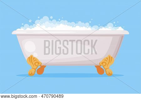 Cast Iron Bathtub On Claw Foot Pedestal Full Of Water With Soap Bubbles Foam Isolated On Blue Backgr