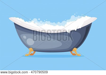 Cast Iron Bathtub On Claw Foot Pedestal Full Of Water With Soap Bubbles Foam Isolated On Blue Backgr