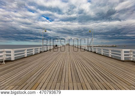 Sopot, Poland - April 2022: Beautiful Long Wooden Pier With Lamps On Both Sides And Walking People