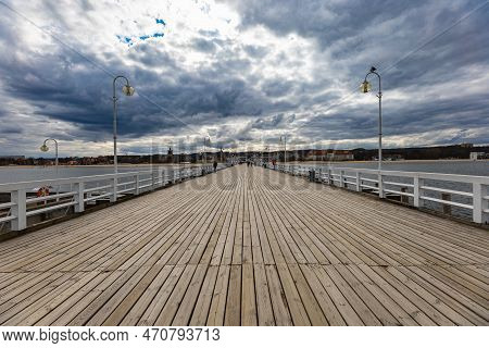 Sopot, Poland - April 2022: Beautiful Long Wooden Pier With Lamps On Both Sides And Walking People