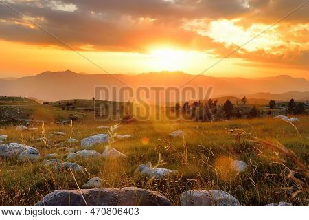 Picturesque Sunset Over A Mountain Valley. Breathtaking View Of The Mountains In The Last Rays Of Th
