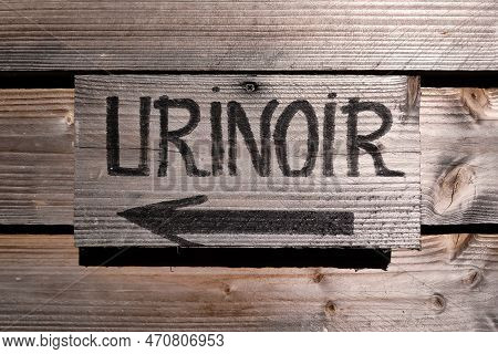 Wooden Sign On A Board Wall Stating In French 
