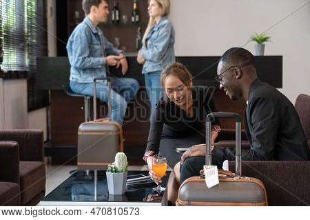 Airport Lounge Waitress Serving Orange Juice To African Businessman Passenger. Black Male Waiting Fo