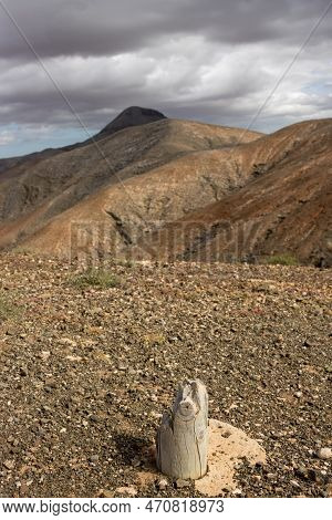 Shapes And Lines Of The Mountains Of The Volcanic Origin. Light Brown Color Of The Soil. Sky With Cl