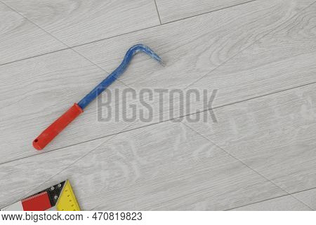 Nail Puller On Laminate Flooring, Top View. Space For Text