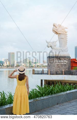 Woman Traveler With Yellow Dress Visiting In Da Nang. Tourist Sightseeing The River View With Carp D