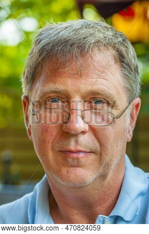 Portrait Of Smiling Man With Reading Glasses