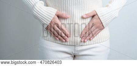 Woman Holding  Her Belly. Pregnancy, Reproductive System, Menstruation, And Gynecology Concept