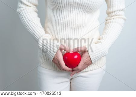 Woman Holding  Red Heart Shape. Pregnancy, Reproductive System, Menstruation, And Gynecology Concept