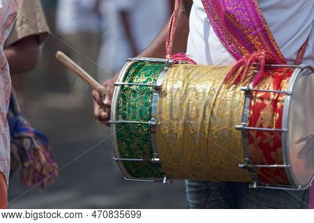 Close-up On A Musician Playing With A Dholak During A Tamil Festival.