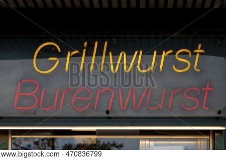Close-up On A Red Neon Light Shaped Into The German Words 