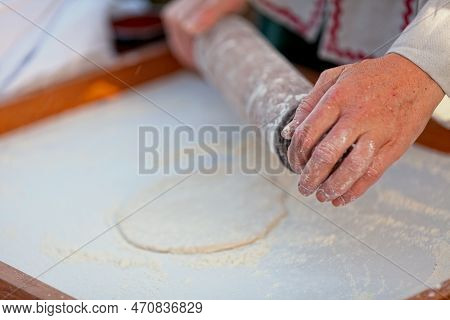 Medieval Baker Making A Fouace, (also Known As Fouée). It Is A Round And Airy Bread From The Western