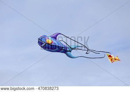 Fish-like Kite Flying In Mid-air During The Wind And Kite Festival In Porspoder, Brittany.