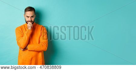 Thougtful Young Man Making Decision, Looking Serious And Thinking, Choosing, Standing Near Copy Spac