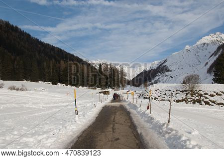 Prastmann, Italy - December 30, 2022: View Of Alpine Road With Tourist And High Dolomites In The Bac