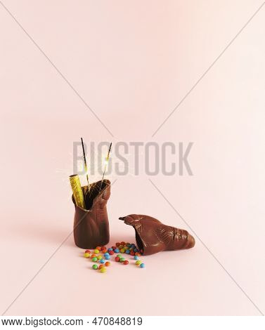 Chocolate Santa Claus Broke In Half  With Burning Sparklers And Scattered Candies On The Flour. Crep