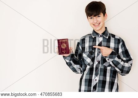 Young Teenager Boy Holding Greece Passport Looking Positive And Happy Standing And Smiling With A Co
