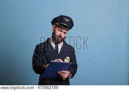 Airplane Captain Holding Clipboard, Concentrated Pilot Writing Papers. Aircraft Aviator In Professio