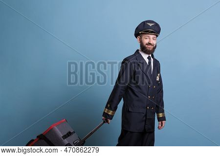 Airplane Pilot In Professional Airline Uniform Standing With Baggage, Looking At Camera. Ready Pilot