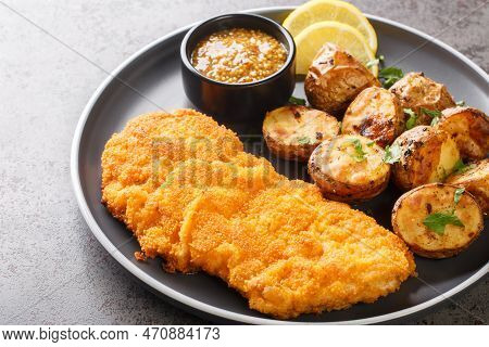Delicious German Munich Schnitzel Fried Breaded With Mustard And Horseradish Served With Baked Potat