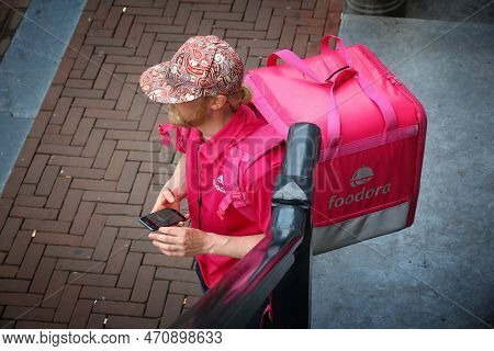 Amsterdam, Netherlands - July 9, 2017: Foodora App Food Couriers Wait In Amsterdam, Netherlands. Bic