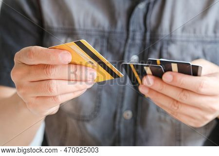Man Holding Several Credit Cards And He Is Choosing A Credit Card To Pay And Spend Payment For Goods