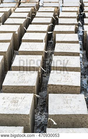 Portrait View Of Rock Bolder. Concrete Cube Over Block Background. Four Square Cinder Blocks In A Ro