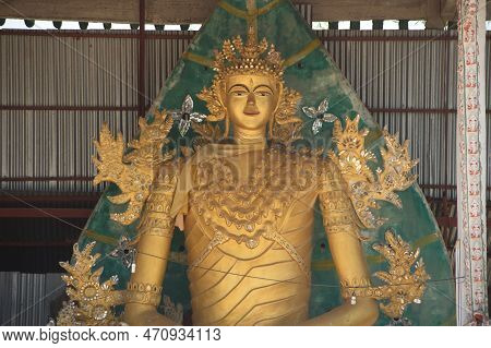 Kanchanaburi , Thailand - Apr 17, 2016 : A Large Indoor Golden Sitting Buddha Image At Wat Somdet In