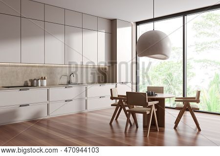 Corner View On Bright Kitchen Room Interior With Dining Table, Armchairs, Panoramic Window, Cupboard