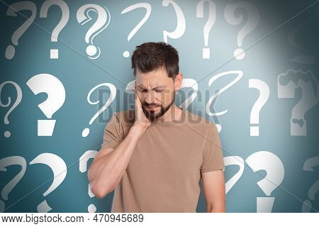 Amnesia Concept. Man Trying To Remember Something. Question Marks On Color Background Symbolizing Me